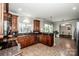 A spacious kitchen features tile floors, wood cabinets, granite counters, and an open layout at 4907 White Oak Ln, Denver, NC 28037