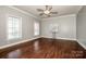 A well lit living room features hardwood floors, neutral colors, and a ceiling fan, creating an inviting atmosphere at 4907 White Oak Ln, Denver, NC 28037