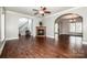 A spacious living room features hardwood floors, a fireplace, archways, and neutral colors, creating an inviting atmosphere at 4907 White Oak Ln, Denver, NC 28037