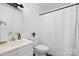 This bathroom features a toilet, sink, and shower with neutral colors at 517 S Central Ave, Landis, NC 28088