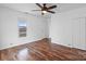 Bright bedroom featuring wood-look floors, ceiling fan, and window at 517 S Central Ave, Landis, NC 28088