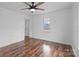 Inviting bedroom with a ceiling fan, wood-look flooring, and natural light at 517 S Central Ave, Landis, NC 28088