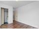 This bedroom offers a utility closet and wood-look flooring at 517 S Central Ave, Landis, NC 28088