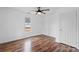 This bedroom features a window for natural light, wood-look flooring, and a spacious feel at 517 S Central Ave, Landis, NC 28088