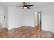 Bright bedroom featuring wood-look floors, ceiling fan, and closet at 517 S Central Ave, Landis, NC 28088