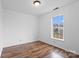 Charming bedroom with wood-look flooring and a window with a view of the outdoors at 517 S Central Ave, Landis, NC 28088