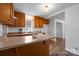 Well-lit kitchen with breakfast bar and wood cabinets at 517 S Central Ave, Landis, NC 28088