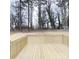 A wood deck provides views of the treed backyard at 519 N State St, Lincolnton, NC 28092