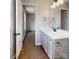 This bathroom features a vanity with modern fixtures and wood-look laminate floors at 519 N State St, Lincolnton, NC 28092