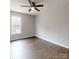 This well-lit bedroom features hardwood floors, a ceiling fan and a large window at 519 N State St, Lincolnton, NC 28092