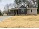 Charming single-story home features gray siding, a welcoming front porch, and a well-maintained yard at 519 N State St, Lincolnton, NC 28092