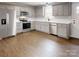 Modern kitchen with stainless steel appliances, white cabinets, and ample counter space at 519 N State St, Lincolnton, NC 28092