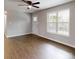 Bright living room featuring laminate floors, ceiling fan, and a large window at 519 N State St, Lincolnton, NC 28092