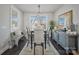 Charming dining room features a modern light fixture, a dining table with seating, and natural light from surrounding windows at 546 Amalfi Dr, Davidson, NC 28036