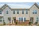 Charming two-story townhome featuring a brick facade and inviting front entrance at 546 Amalfi Dr, Davidson, NC 28036