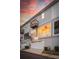 Back exterior of townhome showcasing a covered patio and balcony, with a two-car garage at 546 Amalfi Dr, Davidson, NC 28036