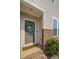 Close-up of the front door with a decorative wreath and brick accents at 546 Amalfi Dr, Davidson, NC 28036