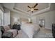 Serene main bedroom offers a tray ceiling, ceiling fan, and comfortable furnishings for a relaxing retreat at 546 Amalfi Dr, Davidson, NC 28036