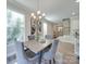 Bright dining room featuring a modern chandelier, neutral walls, and stylish gray upholstered chairs at 574 Altamonte Dr, Clover, SC 29710