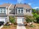 Charming townhome featuring a stone-accented facade, well-manicured landscaping, and an attached one-car garage at 574 Altamonte Dr, Clover, SC 29710