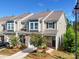 Charming townhome featuring a stone-accented facade, well-manicured landscaping, and an attached one-car garage at 574 Altamonte Dr, Clover, SC 29710