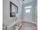 Bright entryway featuring modern console table, decorative mirror, and hardwood flooring at 574 Altamonte Dr, Clover, SC 29710