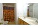 Cozy bathroom featuring a vanity with mirror, neutral wall color, and shower with a colorful curtain at 5834 Coopers Ridge Ln, Charlotte, NC 28269
