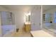 Bright bathroom with a soaking tub and a separate glass enclosed shower at 5834 Coopers Ridge Ln, Charlotte, NC 28269