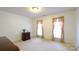 Bedroom featuring neutral carpeting, dresser, and two bright windows at 5834 Coopers Ridge Ln, Charlotte, NC 28269
