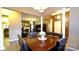 Open dining room with neutral colors, wood floors, and view to living room at 5834 Coopers Ridge Ln, Charlotte, NC 28269
