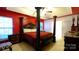 Spacious main bedroom with a four-poster bed and bright natural light at 5834 Coopers Ridge Ln, Charlotte, NC 28269