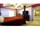 A main bedroom featuring a four-poster bed and a doorway to the bathroom at 5834 Coopers Ridge Ln, Charlotte, NC 28269