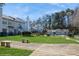 Community backyard featuring a green lawn, a pool and benches at 6212 Windsor Gate Ln, Charlotte, NC 28215