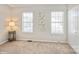 Bedroom with two windows, closet, lamp and neutral walls at 6212 Windsor Gate Ln, Charlotte, NC 28215