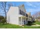 Side view of a two-story townhome with neat landscaping and classic architectural details at 6212 Windsor Gate Ln, Charlotte, NC 28215