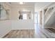 Hallway view into the kitchen, showing neutral paint, gray floors, and staircase at 6212 Windsor Gate Ln, Charlotte, NC 28215