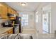 Functional kitchen showcasing wood cabinets, stainless appliances, and view to entryway at 6212 Windsor Gate Ln, Charlotte, NC 28215