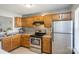 Kitchen showcasing wood cabinets, backsplash, stainless steel appliances, and countertops at 6212 Windsor Gate Ln, Charlotte, NC 28215