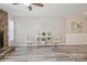 Bright living room featuring stone fireplace, stylish decor, and modern gray flooring at 6212 Windsor Gate Ln, Charlotte, NC 28215