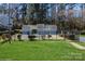 Community pool area with fencing and bathhouse set amongst mature trees and a lush lawn at 6212 Windsor Gate Ln, Charlotte, NC 28215