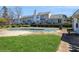 A communal outdoor pool sits behind a row of townhomes, ready for residents to enjoy in warmer months at 6212 Windsor Gate Ln, Charlotte, NC 28215