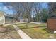 Large, partially fenced backyard with multiple outbuildings, including a storage shed at 6626 Somersworth Dr, Charlotte, NC 28215