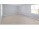 Spacious bedroom with neutral carpet and ample natural light at 6626 Somersworth Dr, Charlotte, NC 28215