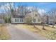 Charming yellow home featuring green shutters and a spacious driveway leading up to the residence at 6626 Somersworth Dr, Charlotte, NC 28215