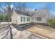 Charming yellow house with green shutters, fenced driveway, and a well-maintained front lawn at 6626 Somersworth Dr, Charlotte, NC 28215