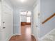 Inviting hallway with hardwood floors leading to rooms with natural lighting at 6626 Somersworth Dr, Charlotte, NC 28215