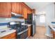 Charming kitchen with wood cabinets, tiled countertops, and gas range at 6626 Somersworth Dr, Charlotte, NC 28215