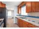 Functional kitchen with stainless steel sink and wood cabinetry at 6626 Somersworth Dr, Charlotte, NC 28215