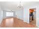 Spacious living room with hardwood floors, chandelier lighting, and views into the kitchen at 6626 Somersworth Dr, Charlotte, NC 28215