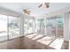 Sunroom featuring hardwood floors, many glass windows, and ceiling fans at 6626 Somersworth Dr, Charlotte, NC 28215